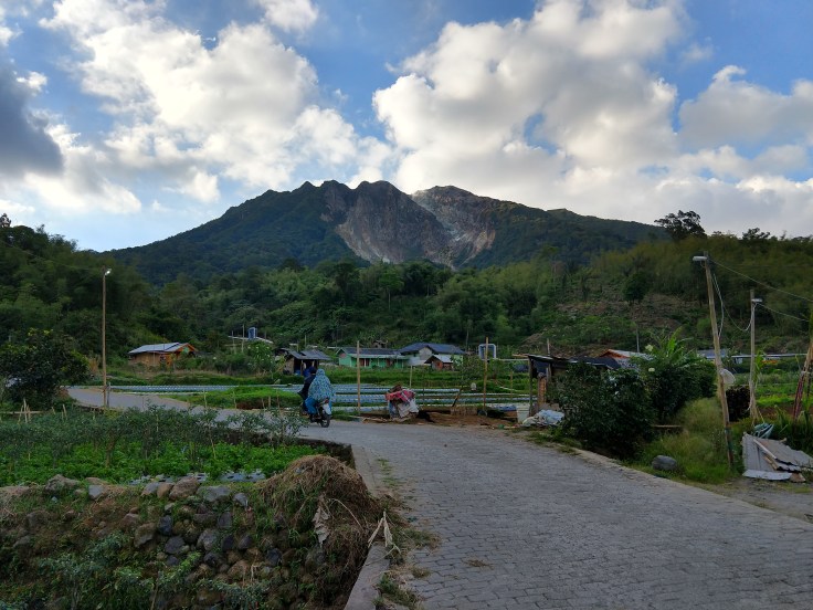 People growing vegetables at the base of Salayak volcano